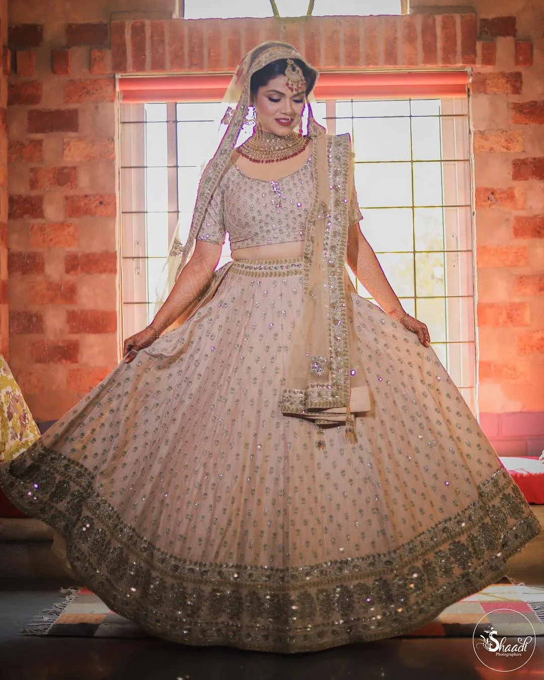 Bride twirling her pastel lehenga before her Gurgaon wedding, portfolio photo by Shaadi Photographers