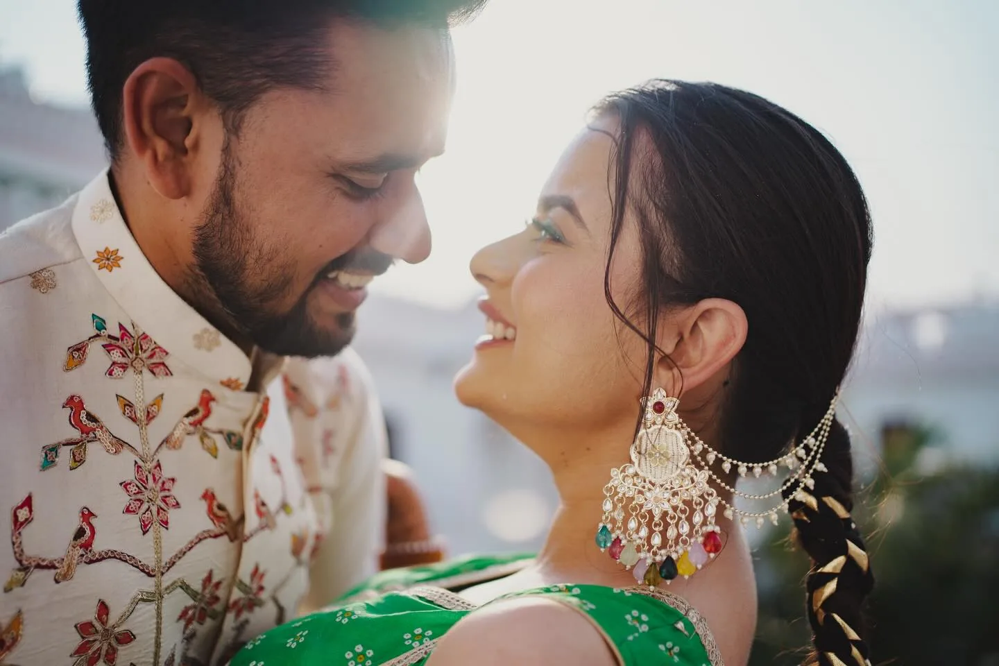 Real pre-wedding couple smiling at each other in festive outfits, portfolio photo by The Knotty Tellers